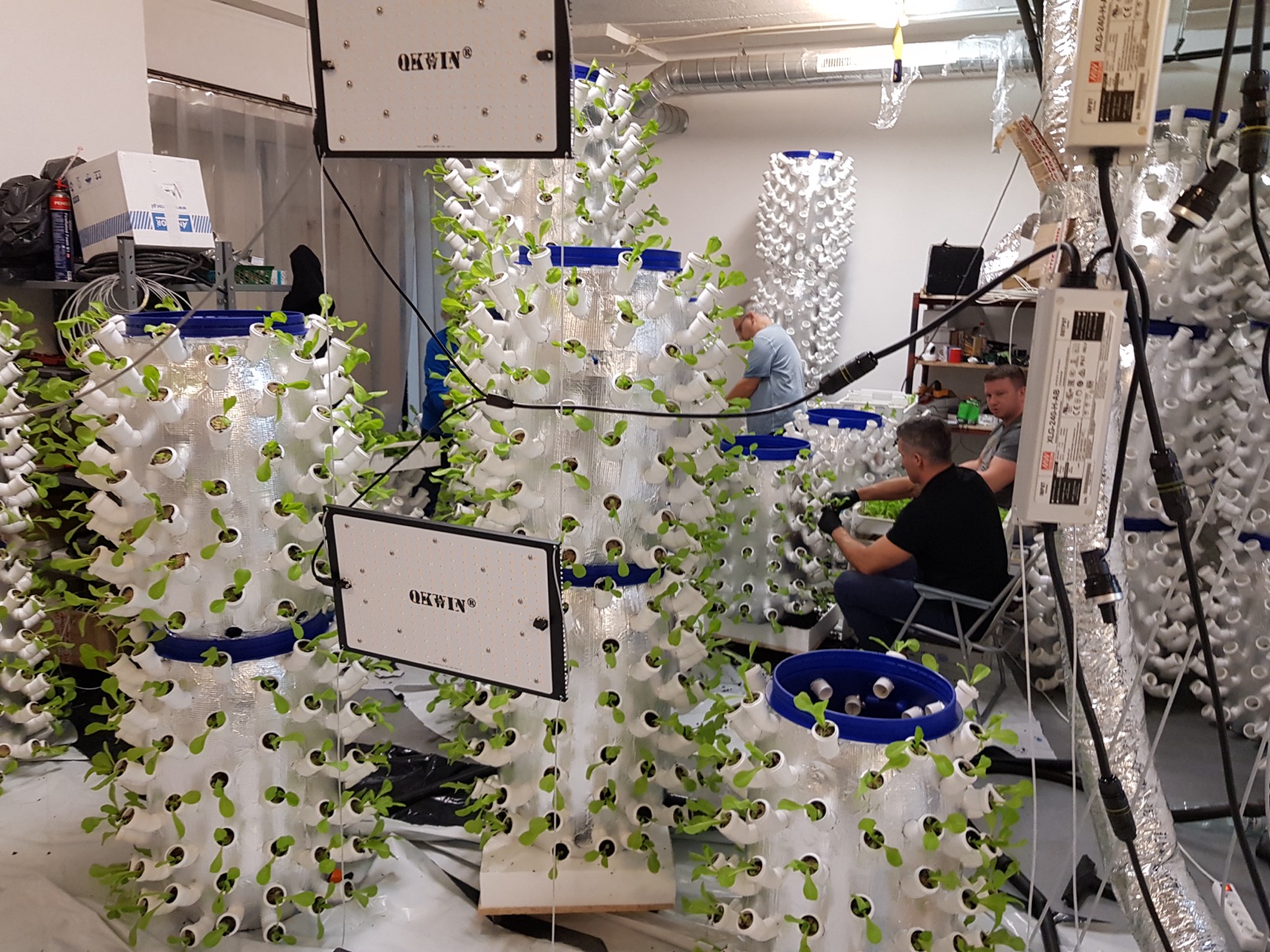 Day 3 — vertical NFT tower assembly in progress, components and tools